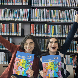 Two Teen Ladies Holding Books