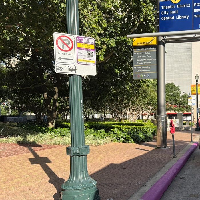 Smart Loading Zone signage and purple curb marking in downtown Houston