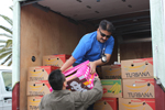 HPD Officer Ted Wang hands supplies to Officer M. Siddiqi